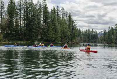 Students kayaking on a river.