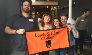 Lewis & Clark alums holding the college banner.