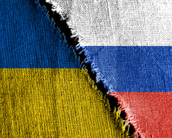 The gap between the two flags, Russia and Ukraine, as a concept of political confrontation.