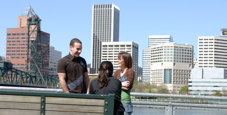 Students chat on the Eastbank Esplanade of Portland's Willamette River.