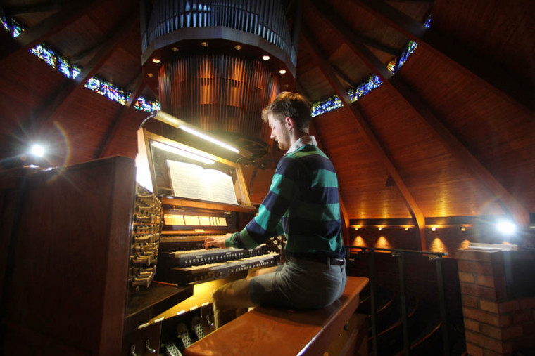 Chris Keady BA '10 plays the circular pipe organ in the Agnes Flanagan Chapel. (AP Photo/Rick Bowmer)