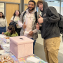 Students line up to send postcards to donors