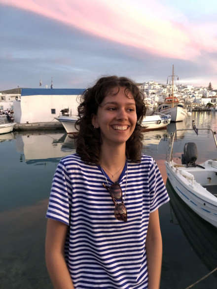 Isabella Boughalem standing in front of boats.