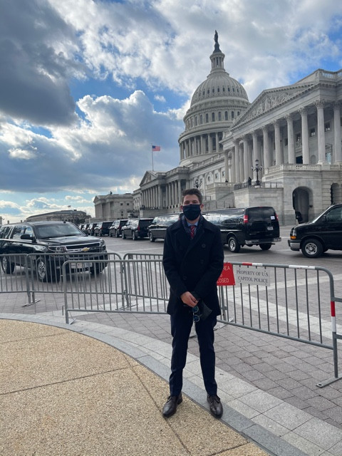 Jackson Thein standing in front of the U.S. Capitol for the 46th Presidential Inauguration.