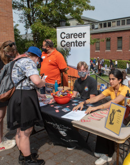 Students at a Career Center table during Pio Fair