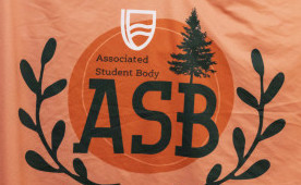 ASB students holding an orange ASB flag.