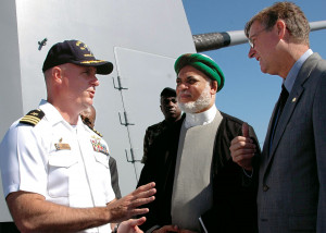 Niels Marquardt (right) and Commander Dean Vesely (left) welcome Comoran President Mohamed Sambi ...