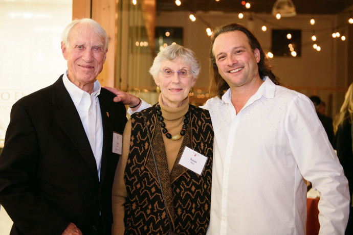 Life Trustee John Bates and Susan Bates with Aaron Meyer BA '95, rock violinist, who provided the...