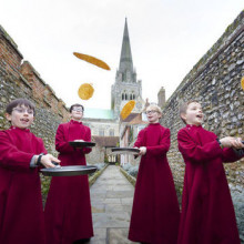 Young choristers flipping pancakes on Pancake Tuesday