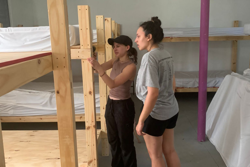 Student leader, Leah, and Program Coordinator, Allison, help construct 16 bunk beds for the volunteer facility they stayed at to support ...