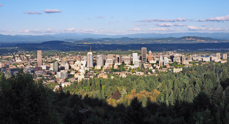 A photograph of the Portland skyline taken from the West Hills on a sunny day.