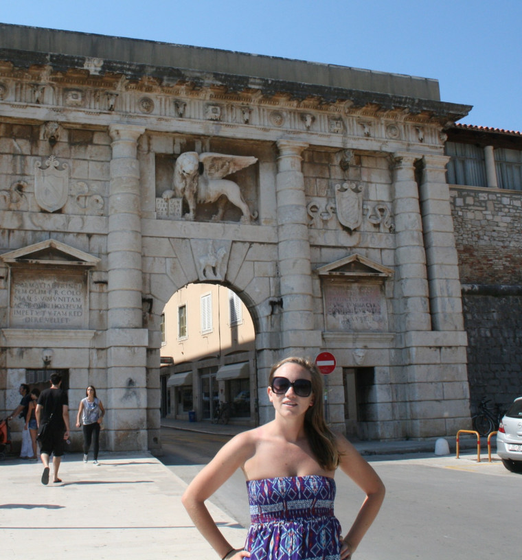 Kelly did some traveling (pictured in Zadar, Croatia) before settling into graduate school at Clark University.