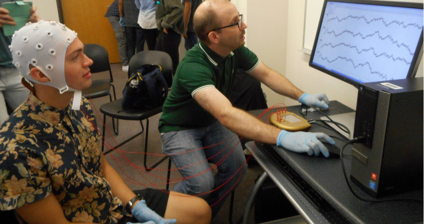 Professor Watson shows students how to collect EEG data.