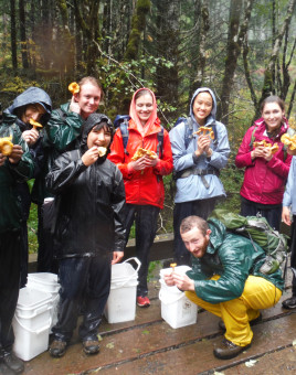 Students showing off the mushrooms they forged on a College Outdoors trip.