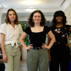 Julia, Lena, and Qwynci standing in a row and smiling directly at the camera.