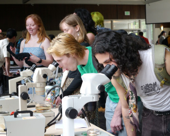 Two students using microscopes.