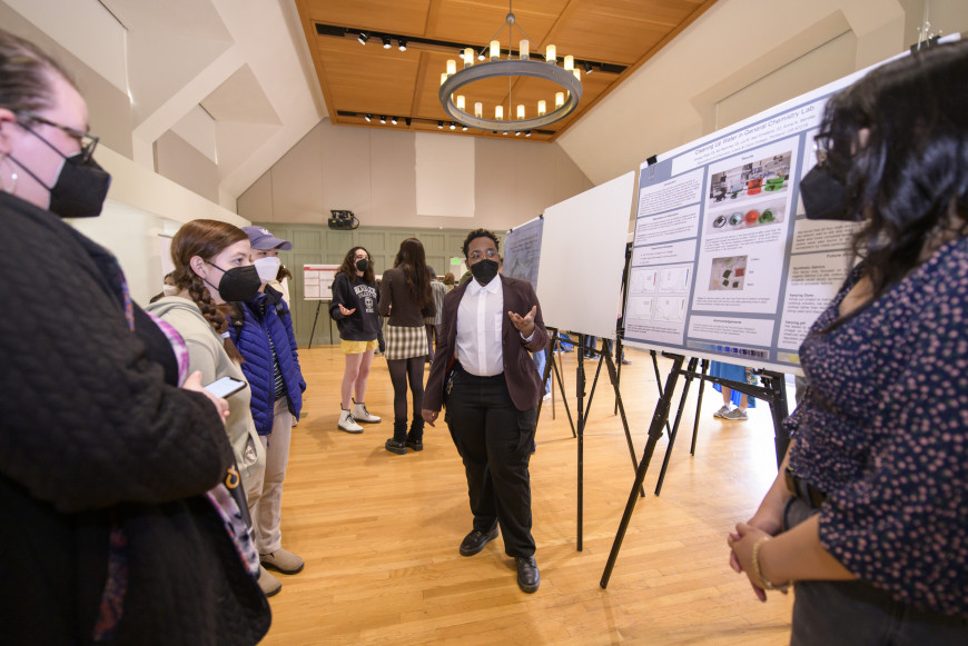Student presenting their research posted during Festival of Scholars and Artists 2022.