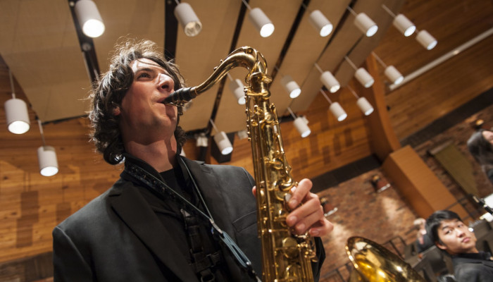 A saxophonist performs with the Lewis & Clark Wind Symphony
